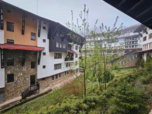 a group of buildings in a city with trees at Частен Апартамент Пампорово Гранд Манастира 2Б5 in Pamporovo