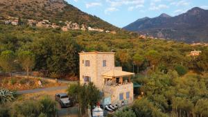 a building with a porch on the side of a mountain at Spitiko Marias in Tséria