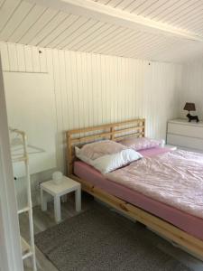 a bedroom with a bed and a ladder and a table at gemütliches Blockhaus - das Hundeparadies am Wald in Wiehl