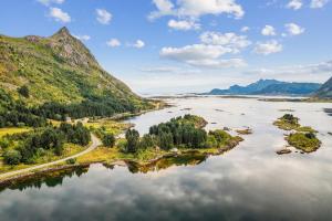 an aerial view of a river with mountains at FLO Lofoten nature escape in Valberg