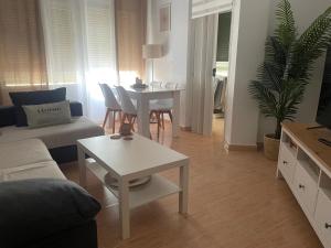 a living room with a couch and a table at Piso acogedor en Barbate in Barbate