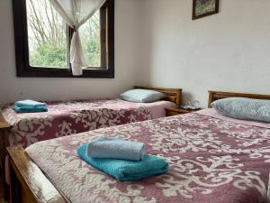 a room with two beds with towels on them at Pensiunea San Pio Sabisa in Săbişa +80 photos
