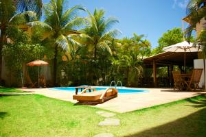 a swimming pool with a resort with a resort at Pousada Stella Tropical in Salvador +9 photos