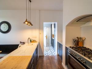 a kitchen with a counter and a clock on the wall at Chic Beamish Retreat Stylish 3-Bed Near Durham - Pass the Keys in Stanley +58 photos