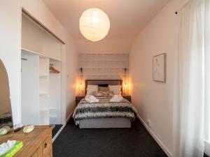 a bedroom with a bed and a chandelier at Chic Beamish Retreat Stylish 3-Bed Near Durham - Pass the Keys in Stanley