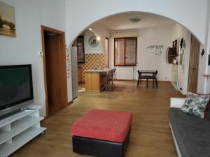 a living room with a couch and a flat screen tv at Casa Mirella in Siena