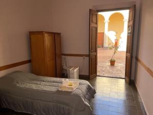 a bedroom with a bed and a bathroom with a toilet at Colegio de María in Cafayate +17 photos