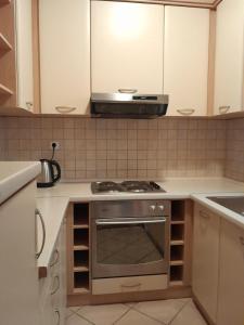 a kitchen with a stove and a microwave at Green House Livno in Livno