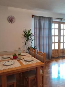 a dining room table with chairs and a table and a table and chairsktop at Green House Livno in Livno