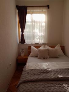 a bedroom with a large bed with a window at Green House Livno in Livno