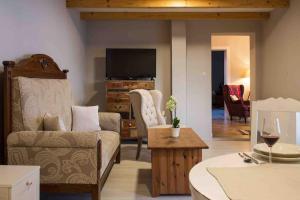 a living room with a couch and a tv at Vila Valentina in Štúrovo