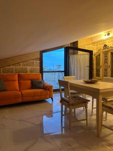 a living room with an orange couch and a table at Castlehawk Resort in Galatone