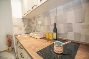 a kitchen counter with a bottle of wine and a glass at Vila Varagic in Budva +34 photos