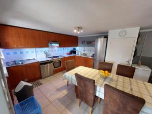 a kitchen with a table and chairs and a refrigerator at Skradin villa et studio in Dubravice