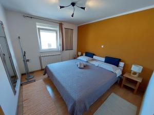 a bedroom with a large bed and a window at Skradin villa et studio in Dubravice +10 photos