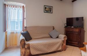 a living room with a couch and a television at Fiammetta in Rovinj