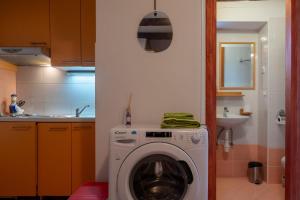 a kitchen with a washing machine in a kitchen at Fiammetta in Rovinj +2 photos