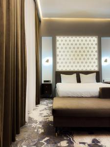 a bedroom with two beds and a window at Jasmine in Taraz