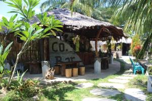 a small shack with a thatched roof at eco trekking lodge, Co Bar & jungle tour's only booking with us ! in Bukit Lawang