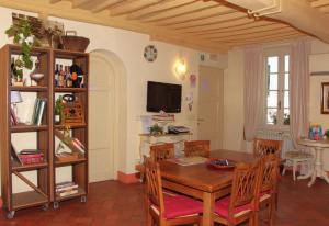 a dining room with a wooden table and chairs at B&B Anfiteatro in Lucca