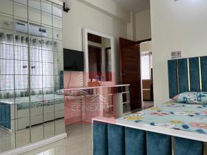 a bedroom with a bed and a dressing room at Fully Furnished One Bed Room Apartment with Kitchen A007 in Dhaka