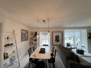 a living room with a table and a couch at A stunning 2 bed apartment in Fishguard +8 photos