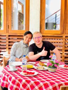a man and a woman sitting at a table at Sigiri Holiday Bungalow in Sigiriya +54 photos