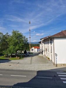a street with a building and a cell phone tower at Klingenbrunner FeWo in Spiegelau