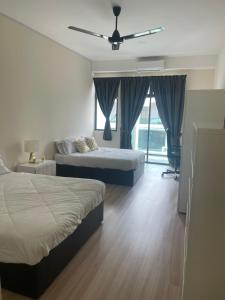 a bedroom with two beds and a ceiling fan at Luxury, Affordable and Spacious Private Villa with Swimming Pool & Jacuzzi for 20 plus ppl Cyberjaya in Cyberjaya +45 photos