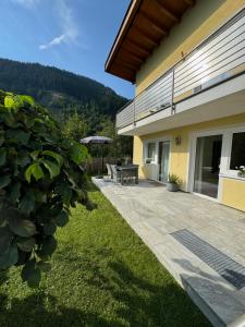 a patio of a house with a picnic table at Appartement Hänsel & Gretel in Werfenweng