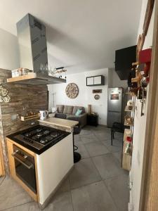 a kitchen and living room with a stove top oven at La locanda delle idee Santa Lucia in Perugia