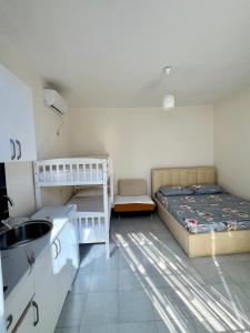 a bedroom with two bunk beds and a sink at Mimi's Apartments in Vlorë