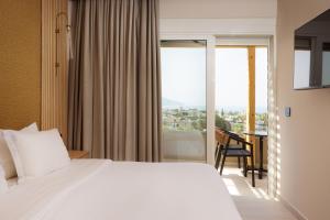 A bed or beds in a room at Sofia Resort Luxury Suites