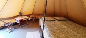 a bedroom with a bed in a tent at Secret Garden Camping in Bontida +45 photos