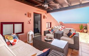 a living room with couches and a table at Luxury 3 bed Duplex Penthouse, 3 mins walk to the beach in Estepona