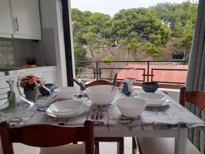 a table with bowls and plates on it with a view at Heraklion Centre Experiene in Heraklio