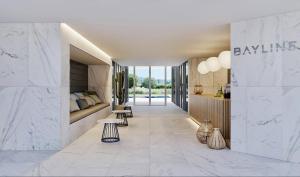 a lobby of a building with two tables and a couch at DLux Terrace Cond Bayline Pool & SPA in Armação de Pêra +50 photos