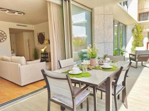 a dining room and living room with a table and chairs at DLux Terrace Cond Bayline Pool & SPA in Armação de Pêra