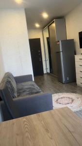 a room with a bed and a refrigerator at Metro city apartment Angisa 72 in Batumi