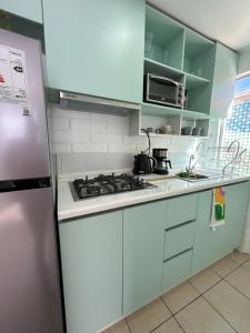 a kitchen with a stove and a refrigerator at Hotel Boutique Paqari casas completamente amobladas in Vallenar +12 photos