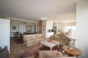 a living room with a couch and a table at Chardon in Langebaan