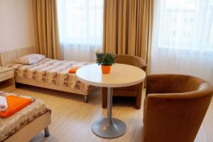 a small room with a table and a bed at Olimpiska Centra Ventspils Hotel in Ventspils +31 photos