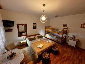 a bedroom with a bed and a bunk bed with a mirror at Guest House Family Varda Plitvice Lakes in Plitvička Jezera