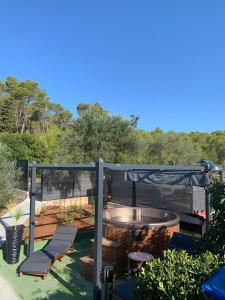 a deck with a table and chairs on a patio at Apartman Lea in Vela Luka