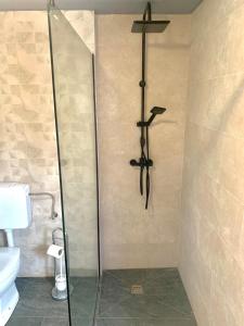 a shower in a bathroom with a cross on the wall at Apartman Lea in Vela Luka +11 photos