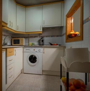 a kitchen with a washing machine and a dishwasher at Casa Amy - Zona Naturista in Playas de Vera