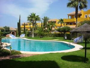 a large swimming pool in front of a resort at Casa Amy - Zona Naturista in Playas de Vera