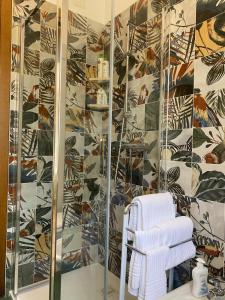 a bathroom with a shower and a white towel at Green Nest in Farra di Soligo