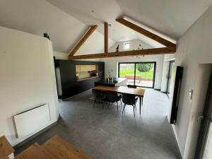 a kitchen and dining room with a table and chairs at Le Domaine Endila in Munster +28 photos