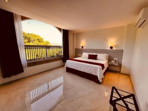a bedroom with a bed and a large window at San Francisco Hotel Boutique in Huajuapan de León